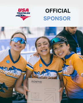 Three smiling female cyclists wearing team uniforms and sunglasses pose with their arms around each other at a USA triathlon event, holding a Renpho Elis Aspire Smart Body Scale with a sponsor's logo. They display